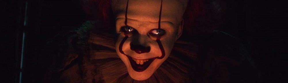 Pennywise grins in the dark in the movie IT: Chapter Two
