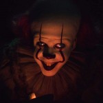 Pennywise grins in the dark in the movie IT: Chapter Two
