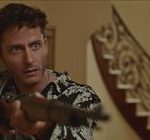 Michael Aloni holds a shotgun at someone in the film Happy Times