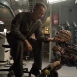 Tom Hanks looks down at his robot dog in the movie Finch