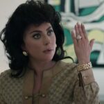 Lady Gaga as Patrizia Reggiani holds up her hand to flash a ring in the movie House of Gucci