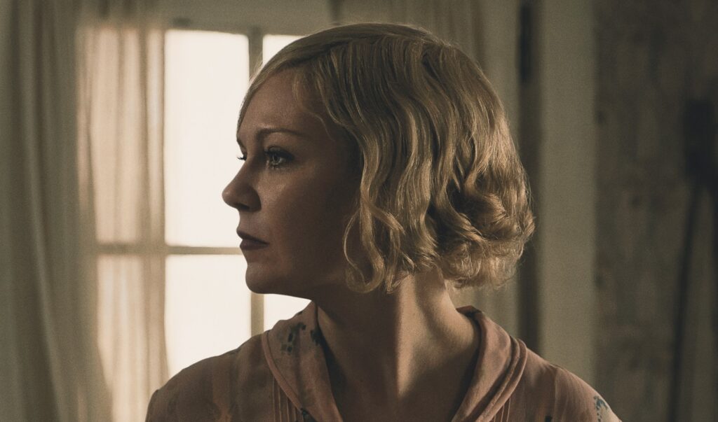 Kirsten Dunst looks to the right with a sad expression in The Power of the Dog