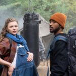 Chloe Grace Moretz and Algee Smith stand together at a campsite looking concerned in the movie Mother Android