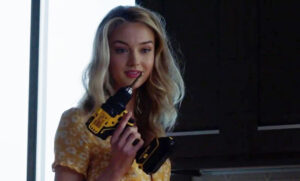 Lilly Krug holds a drill in her hand and smiles deviously in the movie Shattered