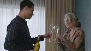 Daryl MacCormack and Emma Thompson clink glasses in Good Luck to You, Leo Grande