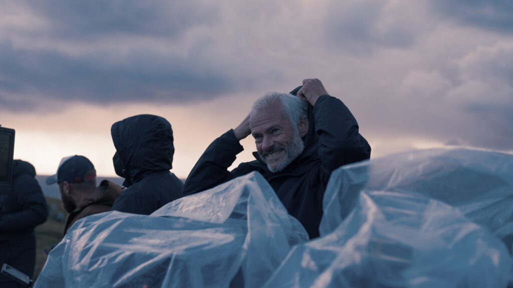 Martin McDonagh puts on his hood while filming The Banshees of Inisherin